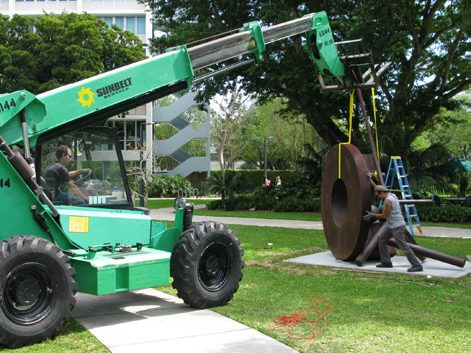 Large-scale sculpture moved into place with a telehandler