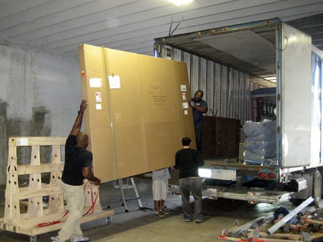 Oversized crated work loaded onto a truck