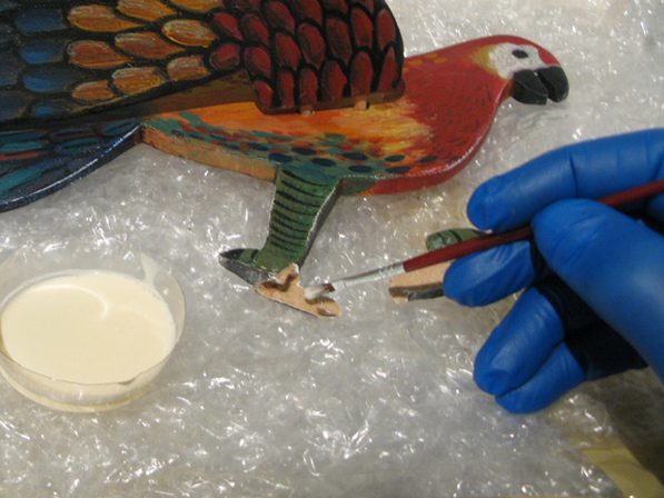 Hand restoration of a painted sculpture